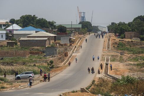 Residents walk towards the Mopani copper mine in Kitwe.
