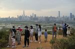 People visit the border of Hong Kong, with the skyline of China's Shenzhen in the background, in Hong Kong Feb. 13, 2021. Hong Kong will start to reopen its border with mainland China on Sunday, Jan. 8, 2023, allowing tens of thousands of people to travel between both sides each day under a quarantine-free arrangement, the city's leader said Thursday, Jan. 5. (AP Photo/Kin Cheung, File)