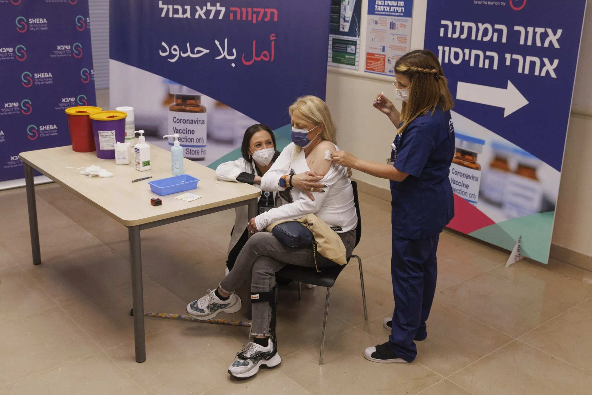 A health worker administers a fourth dose of the Pfizer-BioNTech Covid-19 vaccine in Ramat Gan, Israel.&nbsp;