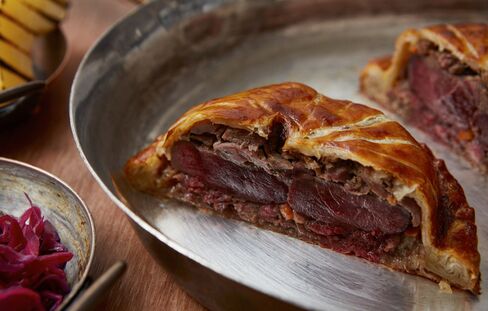 Game pithivier is generously filled and served in beautiful pastry.