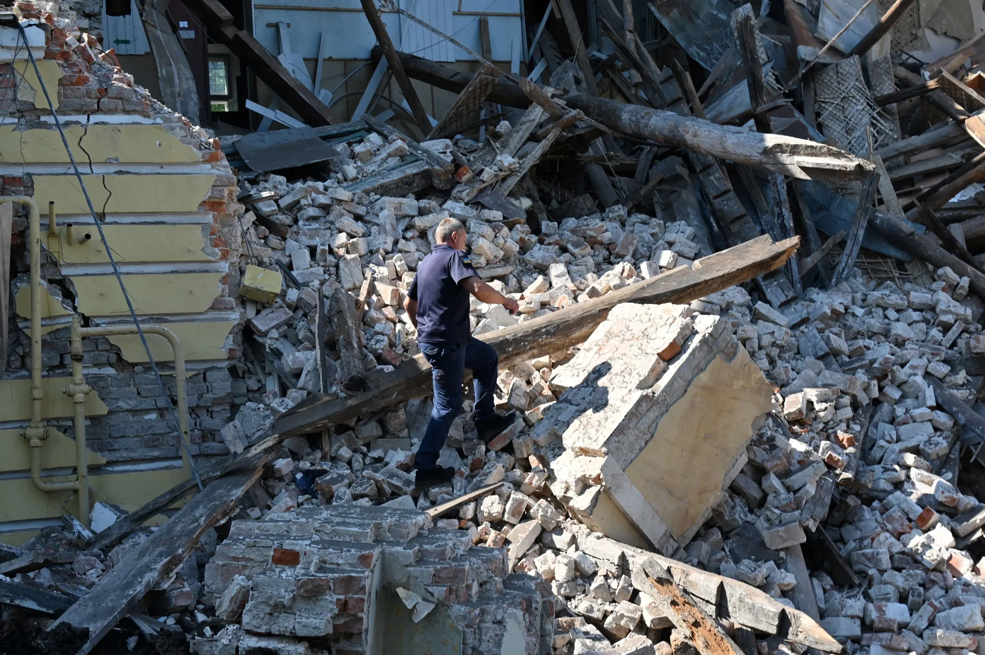 A rescue worker at the site of a destroyed building following a Russian attack,&nbsp;in Kharkiv, Ukraine.