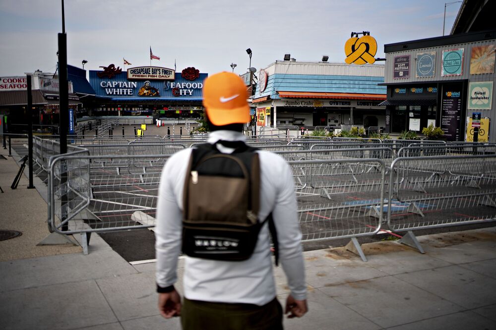 A pedestrian stands outside the temporarily closed fish market in The Wharf neighborhood of Washington, D.C. on April 7.