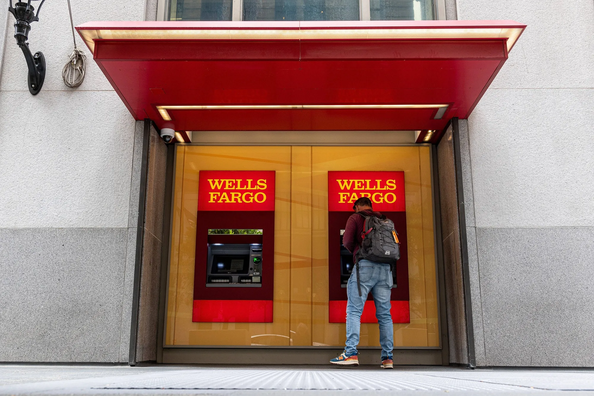A customer uses an&nbsp;ATM&nbsp;at a Wells Fargo bank branch in San Francisco.