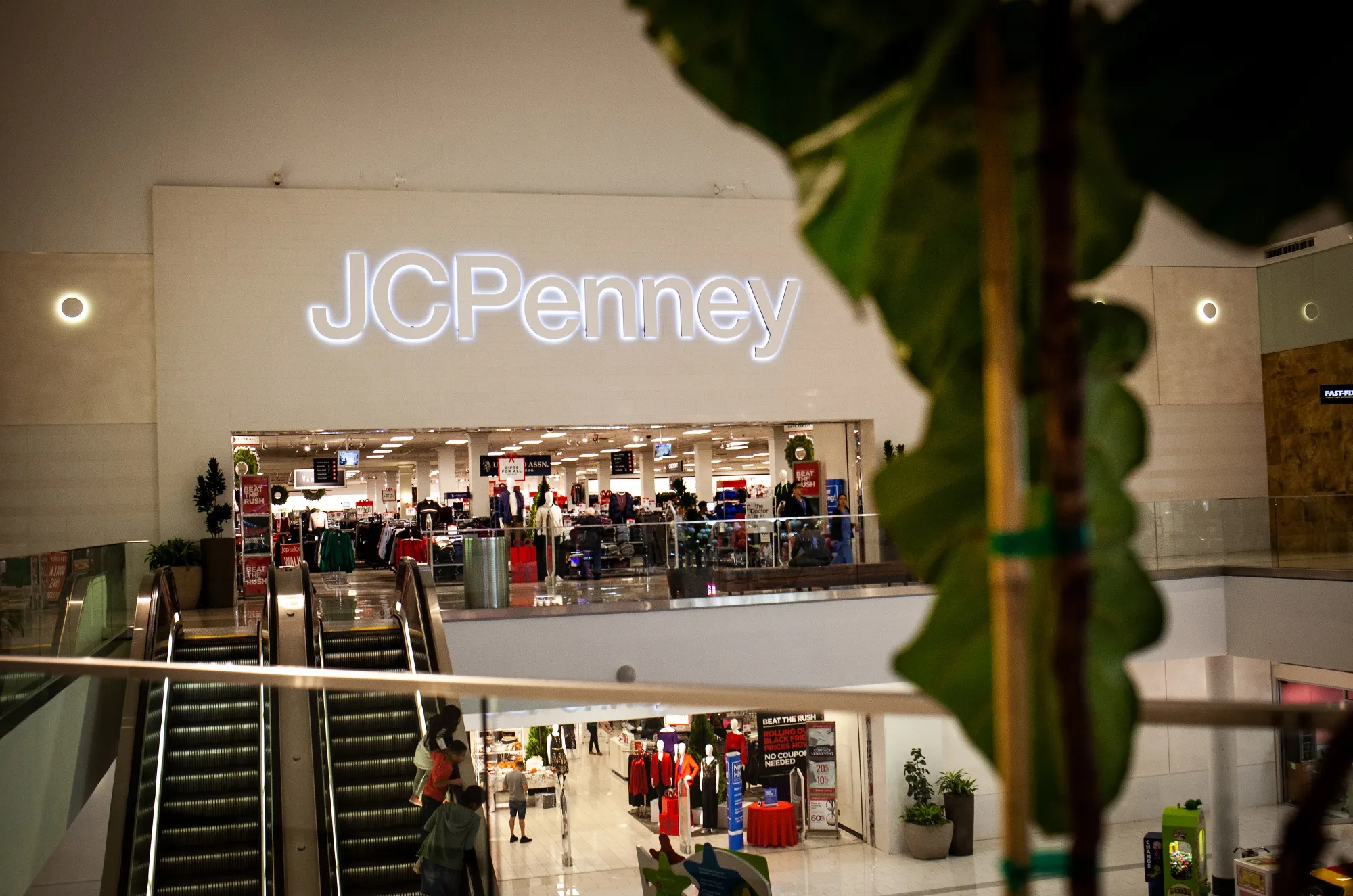 Shoppers ride an escalator near a a J.C. Penney store inside the Westfield Mall in Culver City, California.