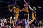 Los Angeles Lakers forward LeBron James (6) passes against Indiana Pacers forward Domantas Sabonis (11) and forward Oshae Brissett (12) during the first half of an NBA basketball game in Los Angeles, Wednesday, Jan. 19, 2022. (AP Photo/Ashley Landis)