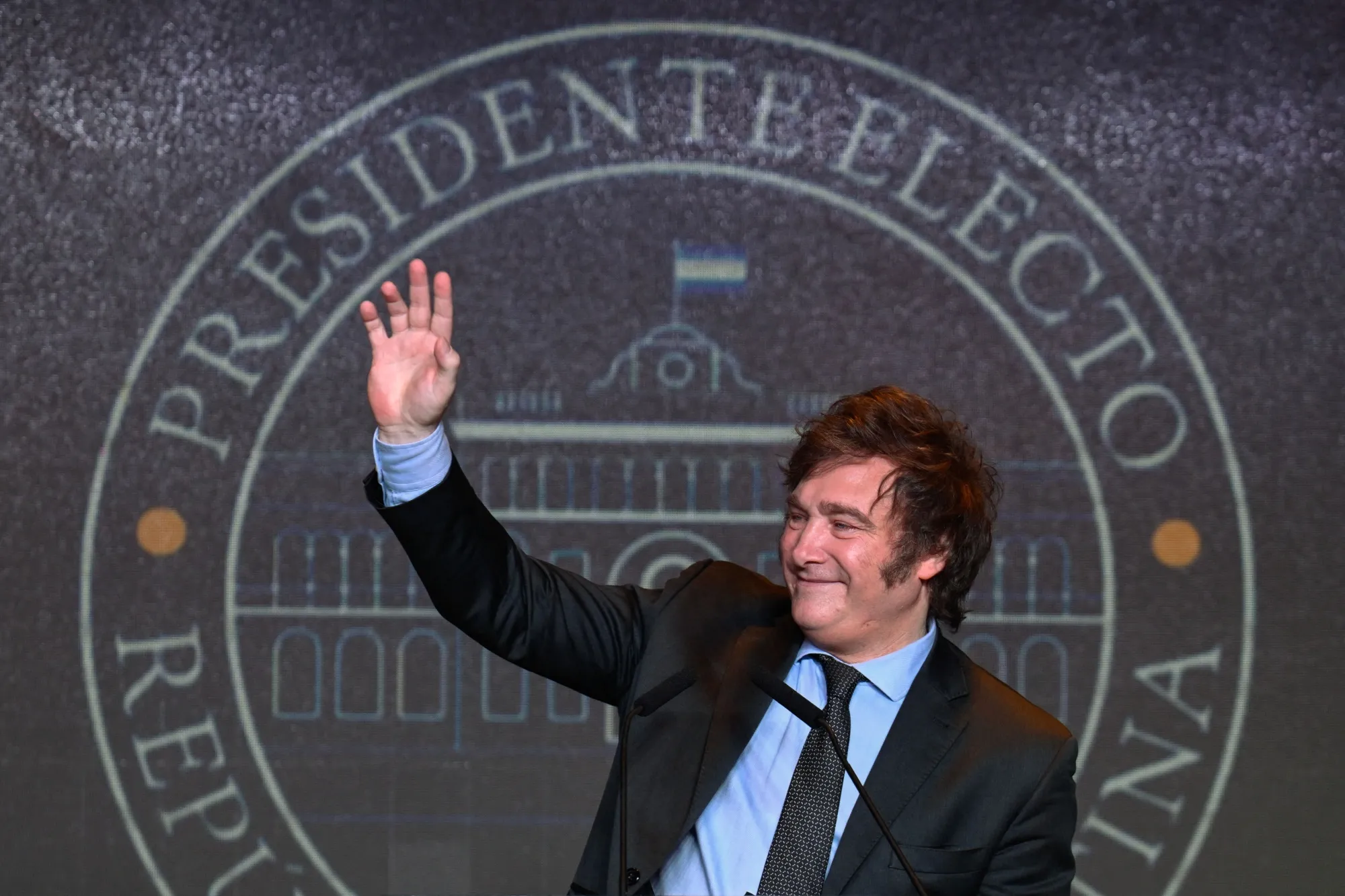 Javier Milei waves to supporters after winning the presidential election runoff in Buenos Aires on November 19.