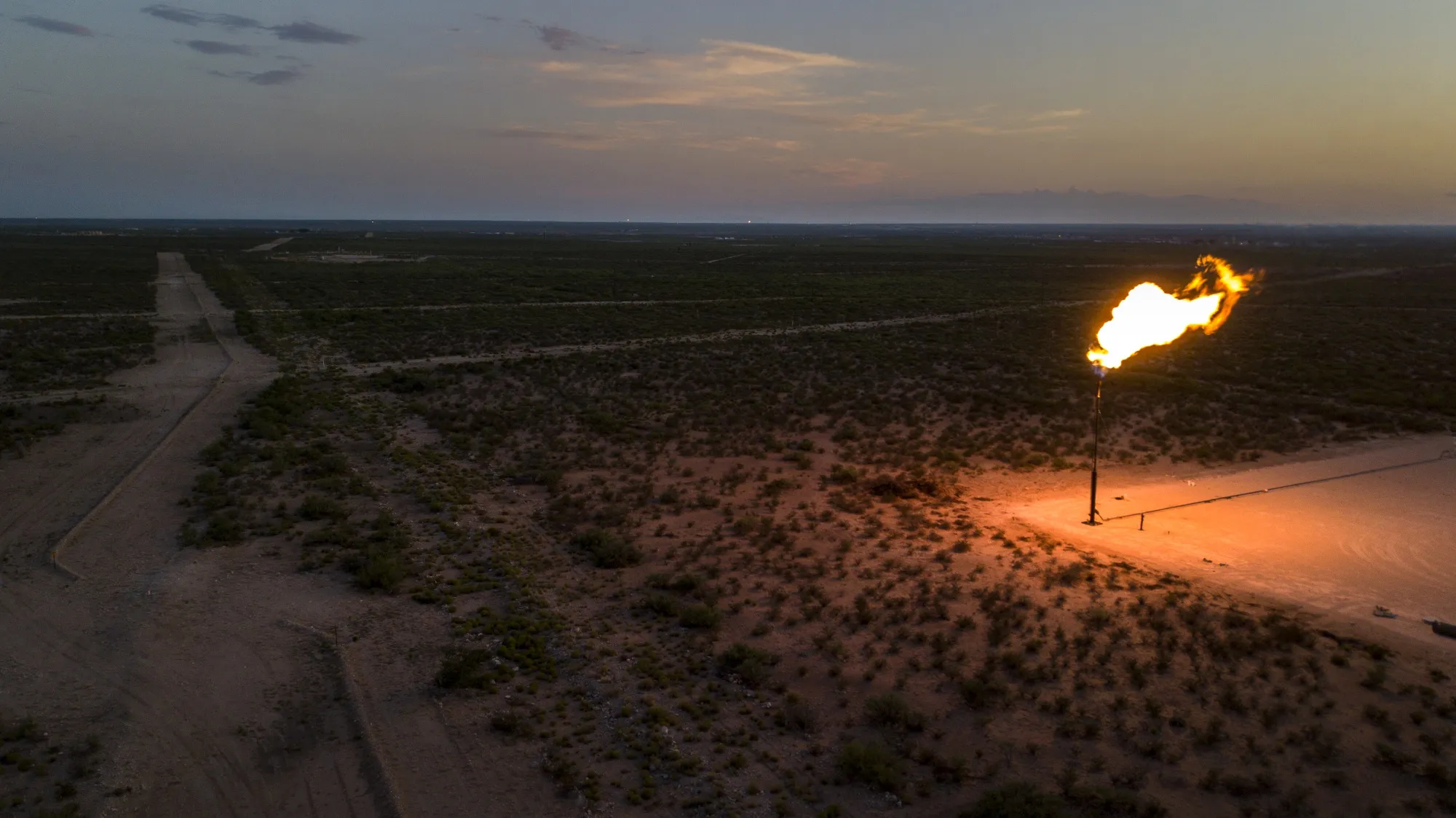 A gas flare is seen at dusk in Texas.