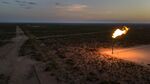 A gas flare is seen at dusk in Texas.