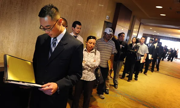 Unemployed Americans line up as they wai