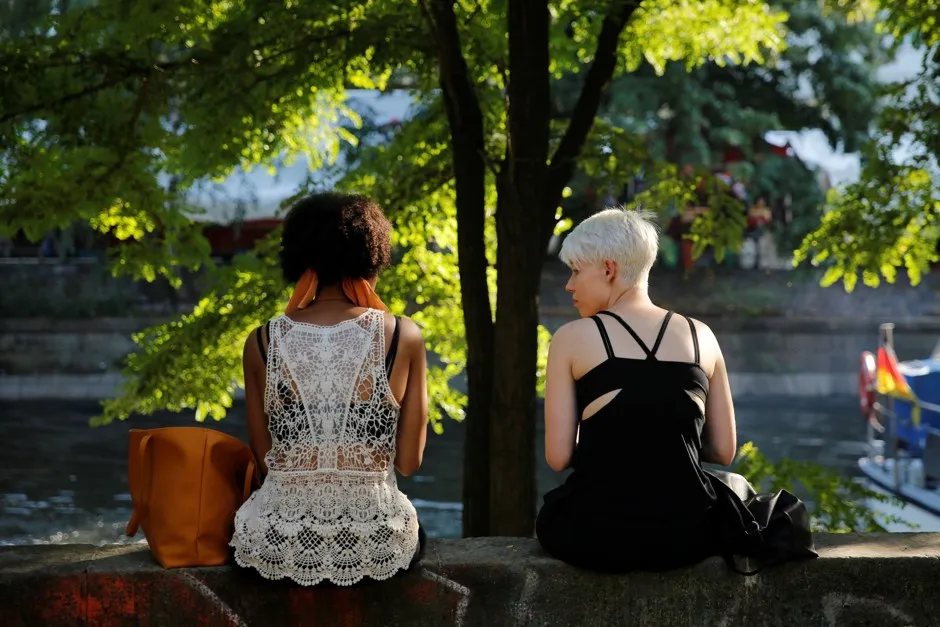 People sit on the canalside in Berlin's Kreuzberg district.
