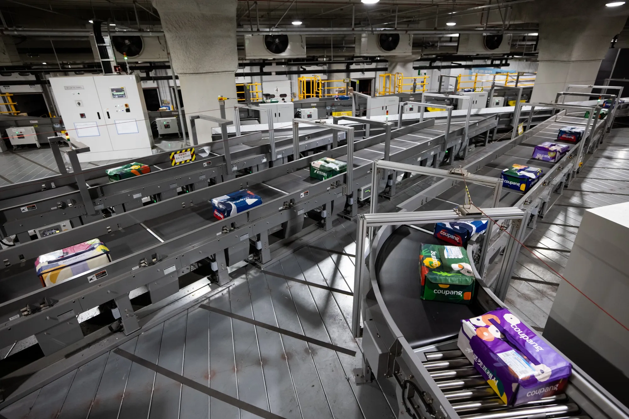 Eco-bags carrying fresh food move along a conveyor belt at a Coupang Corp. fulfillment center in Bucheon, South Korea, on Feb. 19.