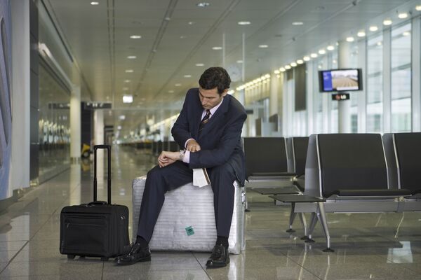 A businessman waiting in the departure lounge.
