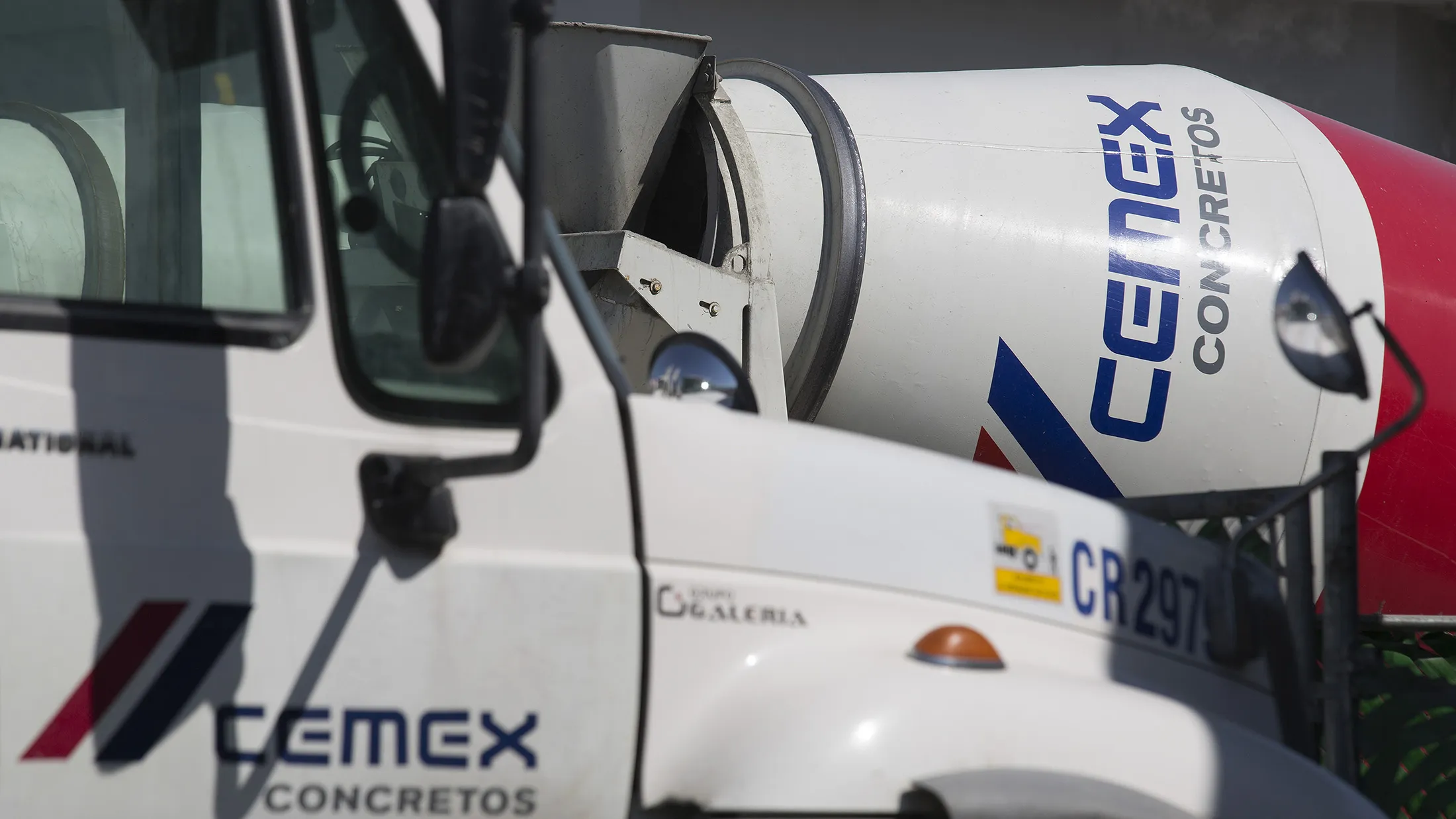 Trucks wait to receive loads of cement at the Cemex SAB plant in Monterrey, Mexico, on Tuesday, Feb. 10, 2015. Cemex SAB's asset sales under its turnaround plan may cut debt by as much as $1 billion as the largest cement maker in the Americas considers disposals in Asia and Northern Europe.
