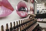 A sales assistant arranges lipsticks at an Estee Lauder Companies Inc. store.