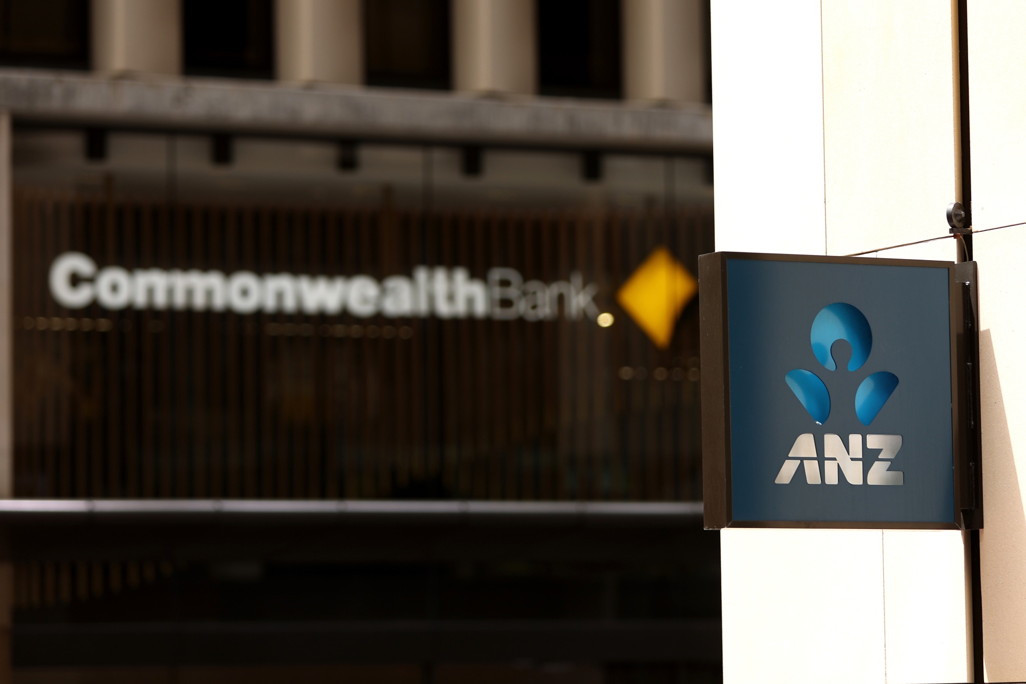 Signage for Australia & New Zealand Banking Group Ltd. (ANZ) and Commonwealth Bank of Australia in Sydney, Australia, on Monday, Oct. 28, 2024. ANZ is scheduled to release full-year earnings figures on Nov. 8. Photographer: Brendon Thorne/Bloomberg
