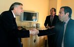 David Martinez, right, shakes hands with former President of Argentina Nestor Kirchner
