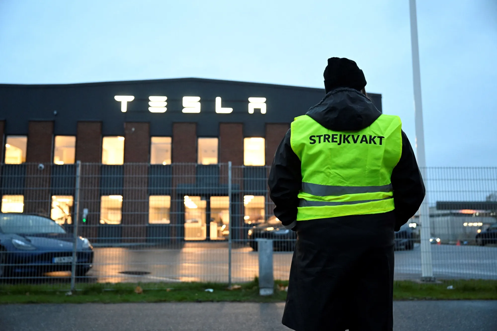 A worker strikes in front of the Tesla Service Center in Segeltorp, Sweden, on Oct. 27.