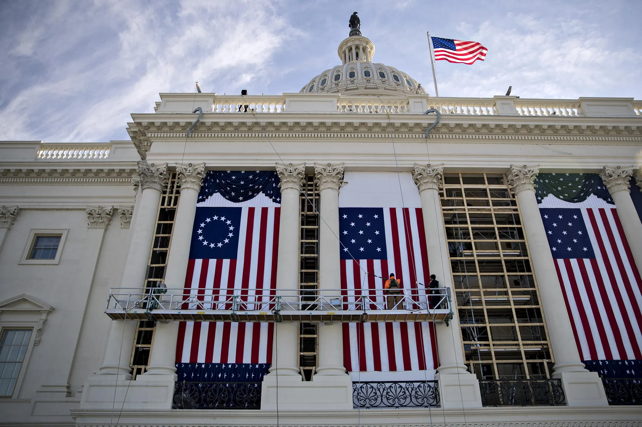Workers adjust an American flag at the U.S. Capitol building during rehearsal for the 2017 Inaugural Ceremonies in Washington, D.C., on Jan. 15.
