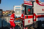 Red Cross workers load a patient into an ambulance in Brescia, Italy, on April 3.