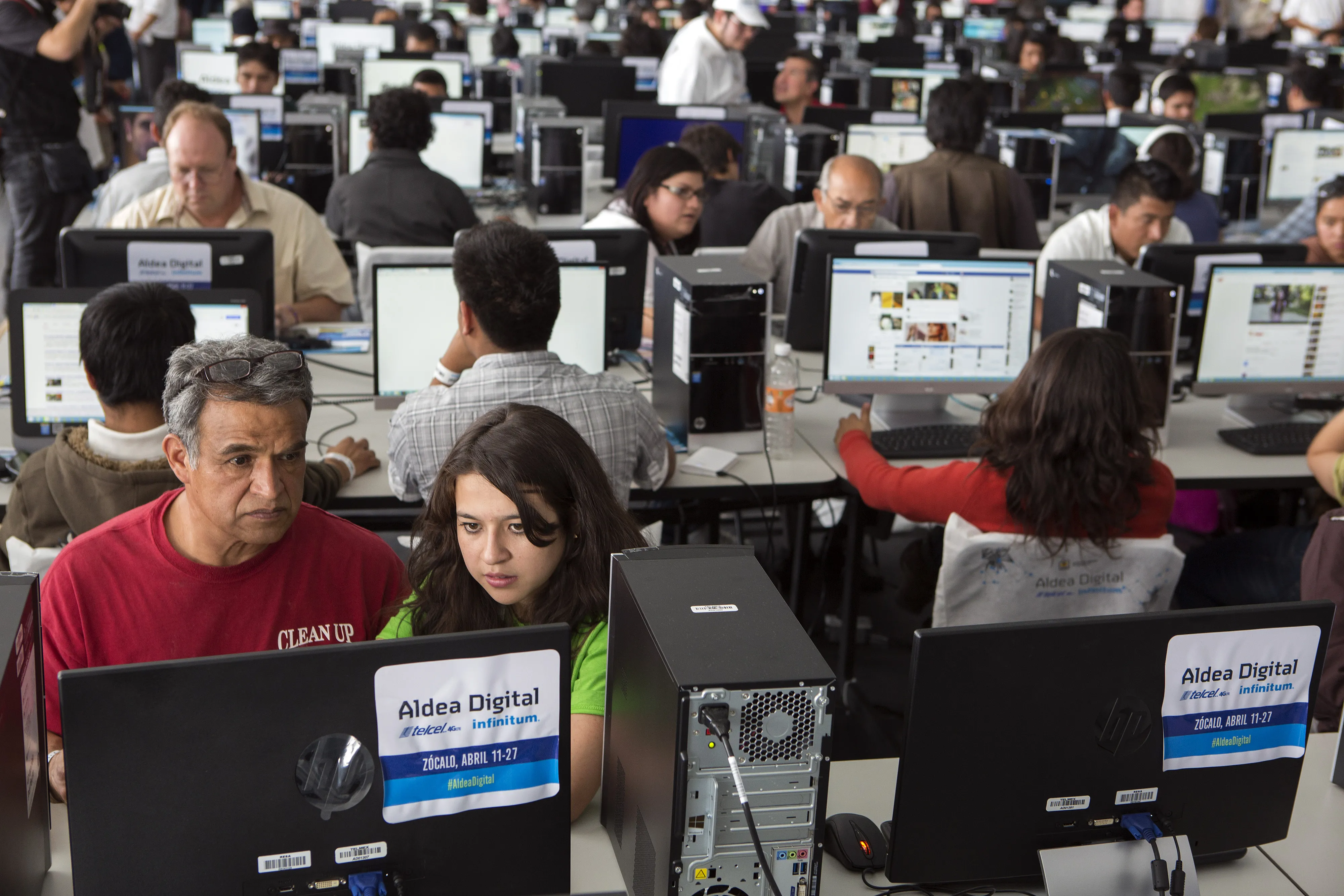 Visitors use the computers inside the Telcel's Digital Village hosted by Telmex and Telcel, and powered by Infinitum, is free and open to the public from April 11 to April 27. Telmex plans to install more than 125 kilometers of fiber optic cable to create a network in the Zocalo where attendees can participate in a wide variety of activities consisting of courses, workshops, conferences, contests and IT project incubation in Mexico City, Mexico on Friday, April 11, 2014.
