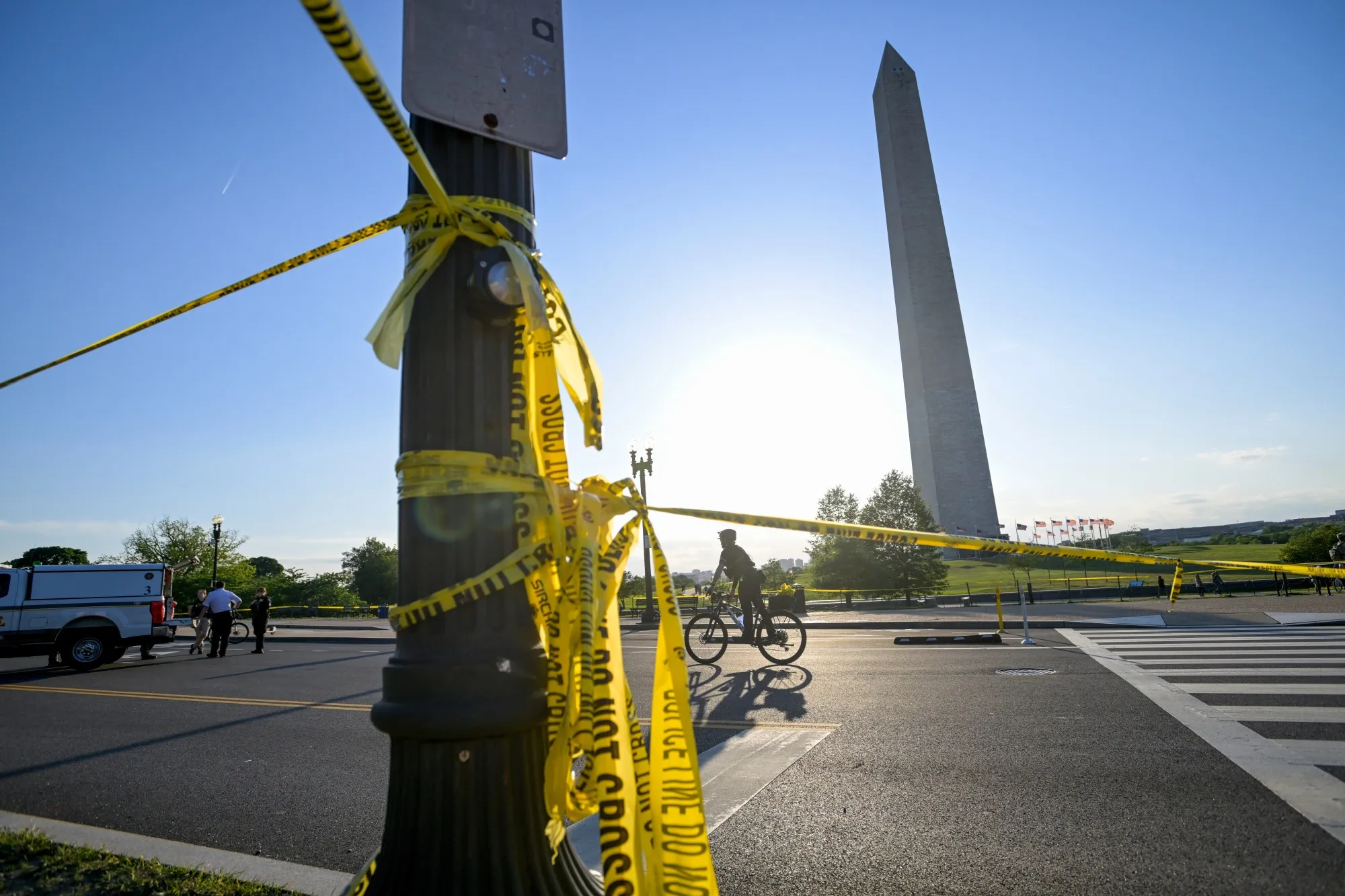 Police tape remains around the scene after a person was shot by law enforcement near the Washington Monument on May 4.