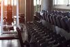 Soft focus the Sport equipment concept dumbbells on rack in fitness gym.