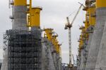 Cranes and scaffold towers at the construction site of gravity-based wind turbine foundations for the Fecamp offshore wind farm at the Bouygues SA works in Le Havre, France, on Monday, April 11, 2022.&nbsp;