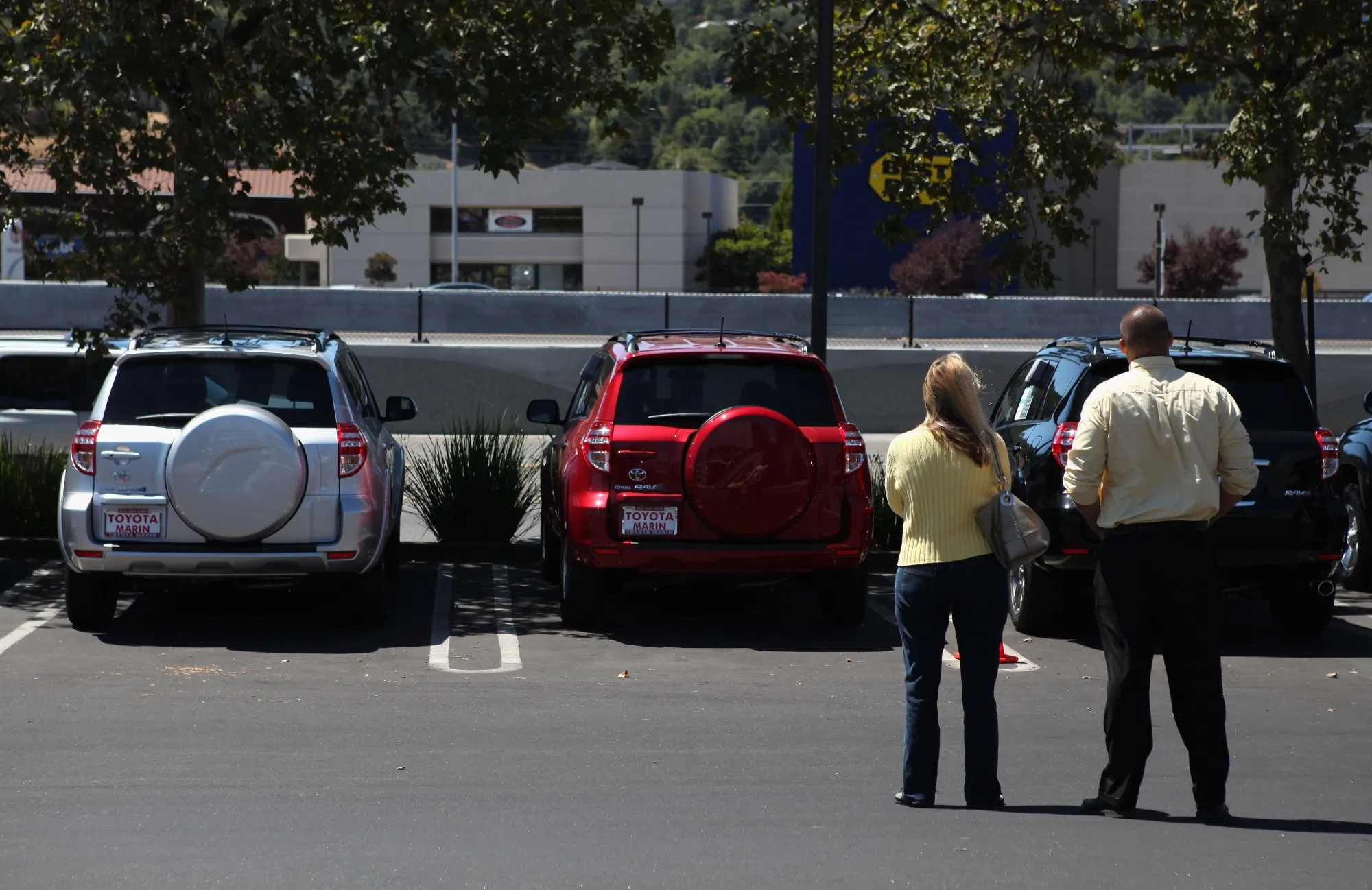 A customer looks at Toyota vehicles with a salesman in San Rafael, California.