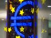 The euro sign sculpture is reflected in office windows as it stands outside the former European Central Bank (ECB) headquarters, at night in Frankfurt, Germany, on Wednesday, Jan. 27, 2016. German domestic demand, buoyed by a stable labor market and low oil prices, will propel the country's economic growth this year and compensate for slowing exports as emerging economies stumbles.