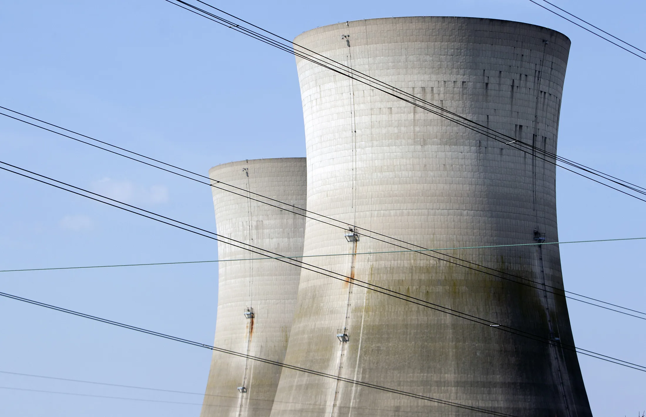 Decommissioned cooling towers sit behind power lines at the Three Mile Island nuclear power plant in Middletown, Pennsylvania, on March 18, 2011.
