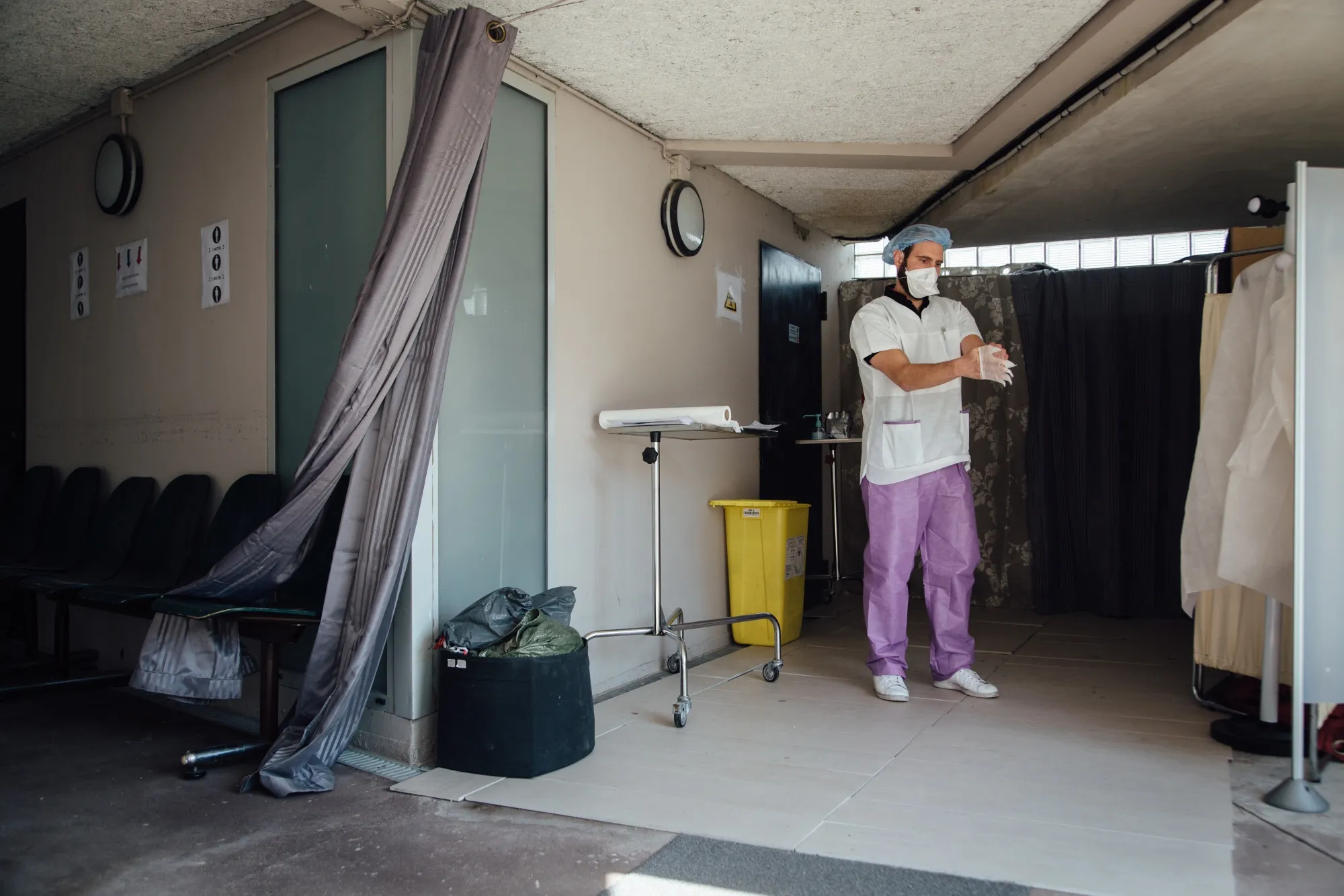 A doctor puts on gloves at a drive-thru coronavirus test center in Paris on April 7.