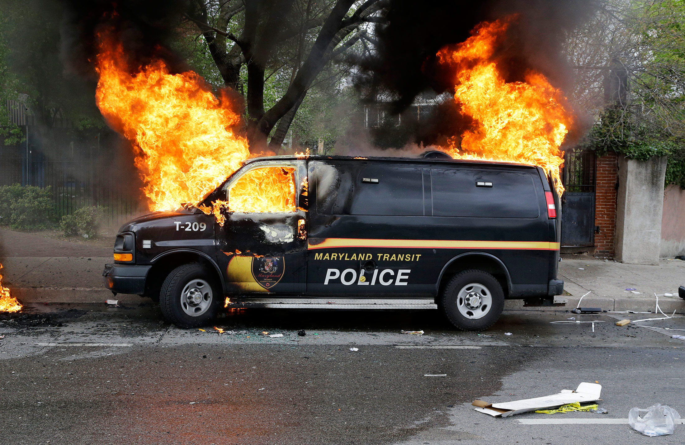 A police vehicle burns, Monday, April 27, 2015, during unrest following the funeral of Freddie Gray in Baltimore.

