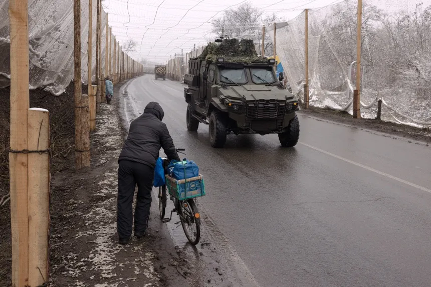 A local resident&nbsp;walks along the E40 highway that connects the cities of Izyum and Slovyansk&nbsp;in Izyum, Kharkiv region, Ukraine.&nbsp;