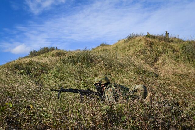 Japanese soldiers practicing an amphibious landing on Tanegashima last November.