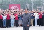 Chinese President Xi Jinping waves to teachers and students during a visit to Renmin University of China in Beijing on April 25.&nbsp;