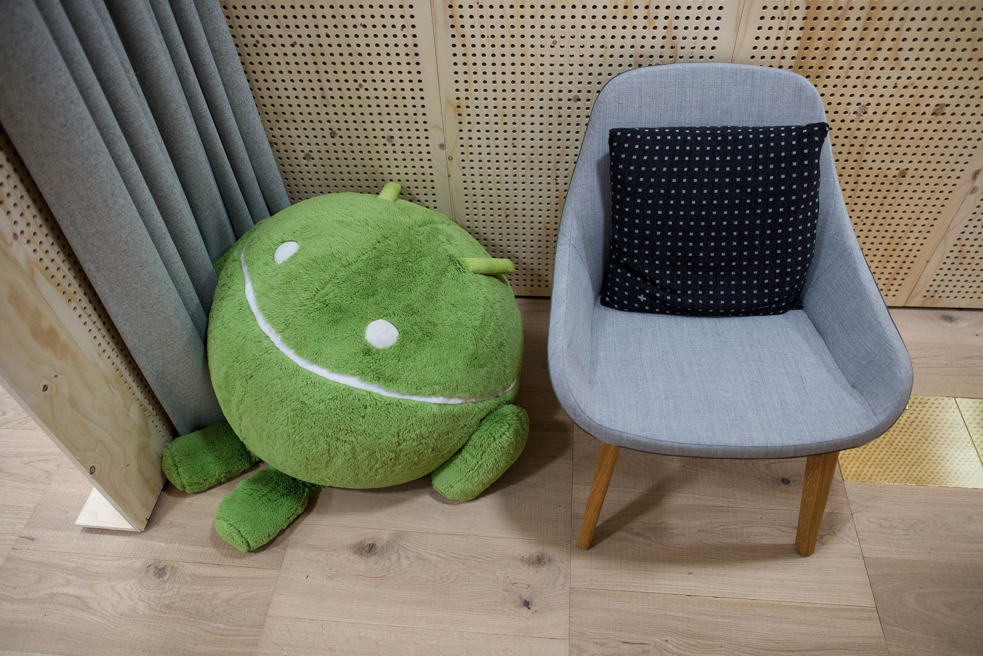 A soft toy depicting the Android logo sits in a workspace at Google Inc.'s Kings Cross office in London, U.K., on Tuesday, Nov. 15, 2016. After being criticized for not paying its fair share of British tax, Alphabet Inc.’s Google unit is trying to show it’s a good corporate citizen by offering five hours of free digital skills training to all U.K. residents.