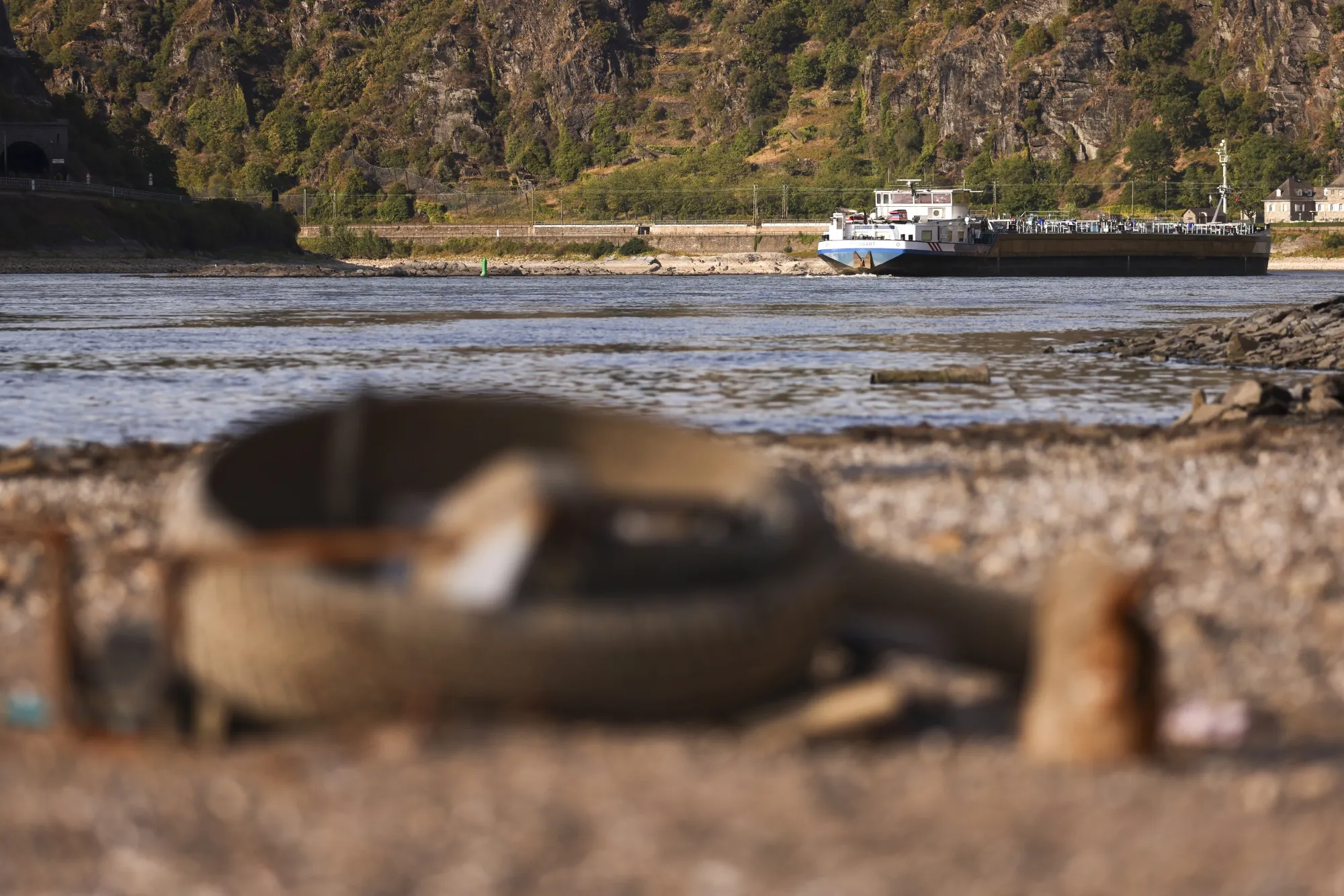 A barge passes an exposed riverbed on the River Rhine near Loreley, Germany, on Aug. 12.