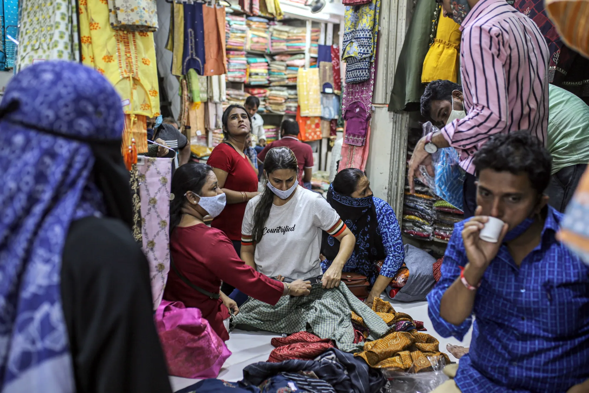 Customers browse fabrics inside Mangaldas Market in Mumbai, on Feb 6.
