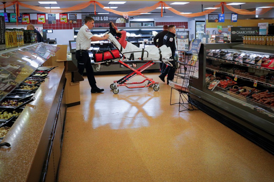 Medics take a woman out of a grocery store where she was found unresponsive after overdosing on opioids.