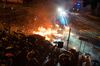 HONG KONG, CHINA - November 18: Protesters throw fire bomb as police fire water canon during a clash at The Hong Kong Poytechnic University on November 18, 2019 in Hong Kong.