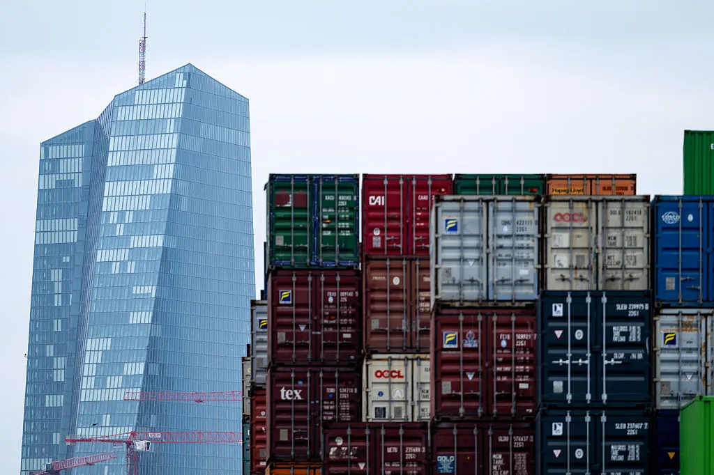 Shipping containers stand stacked in the Frankfurt&nbsp;container port with the ECB headquarters in the distance.