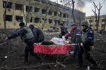 Emergency employees and volunteers transport an injured pregnant woman from a maternity hospital&nbsp;in Mariupol, Ukraine, on March 9.