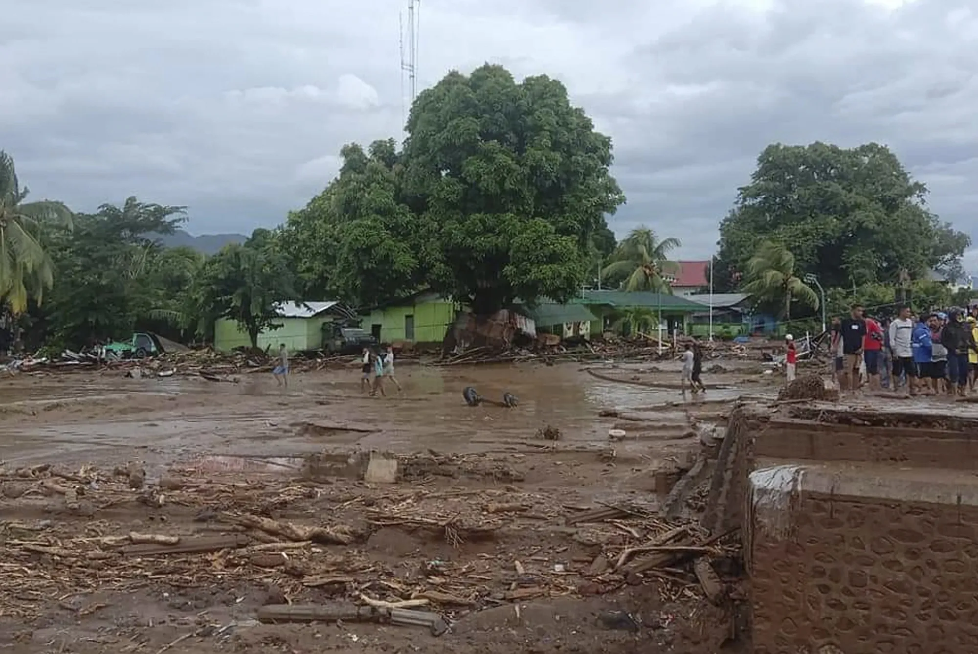 Residents inspect the damage at a village hit by flash flood in East Flores, Indonesia, on Sunday, April 4.