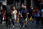People wear protective masks as they walk in the city center of Antwerp, Belgium, on July 27.&nbsp;
