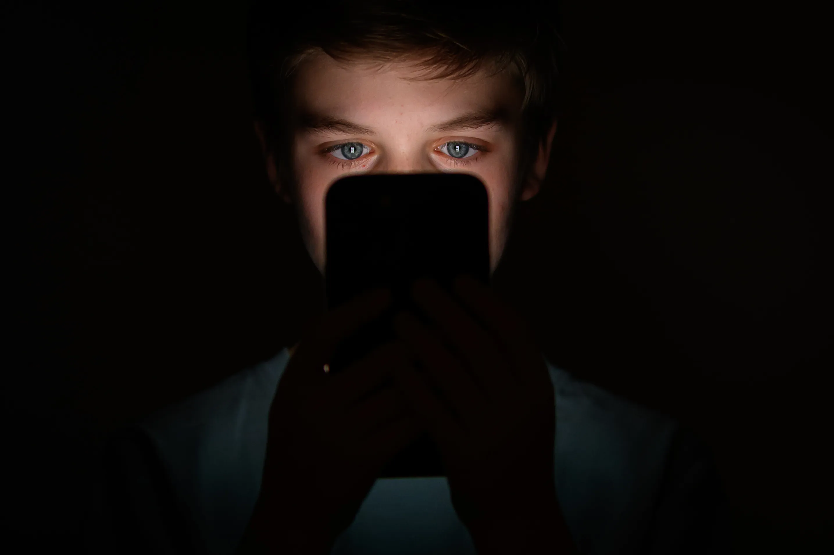 Is he watching the phone, or is the phone watching him?