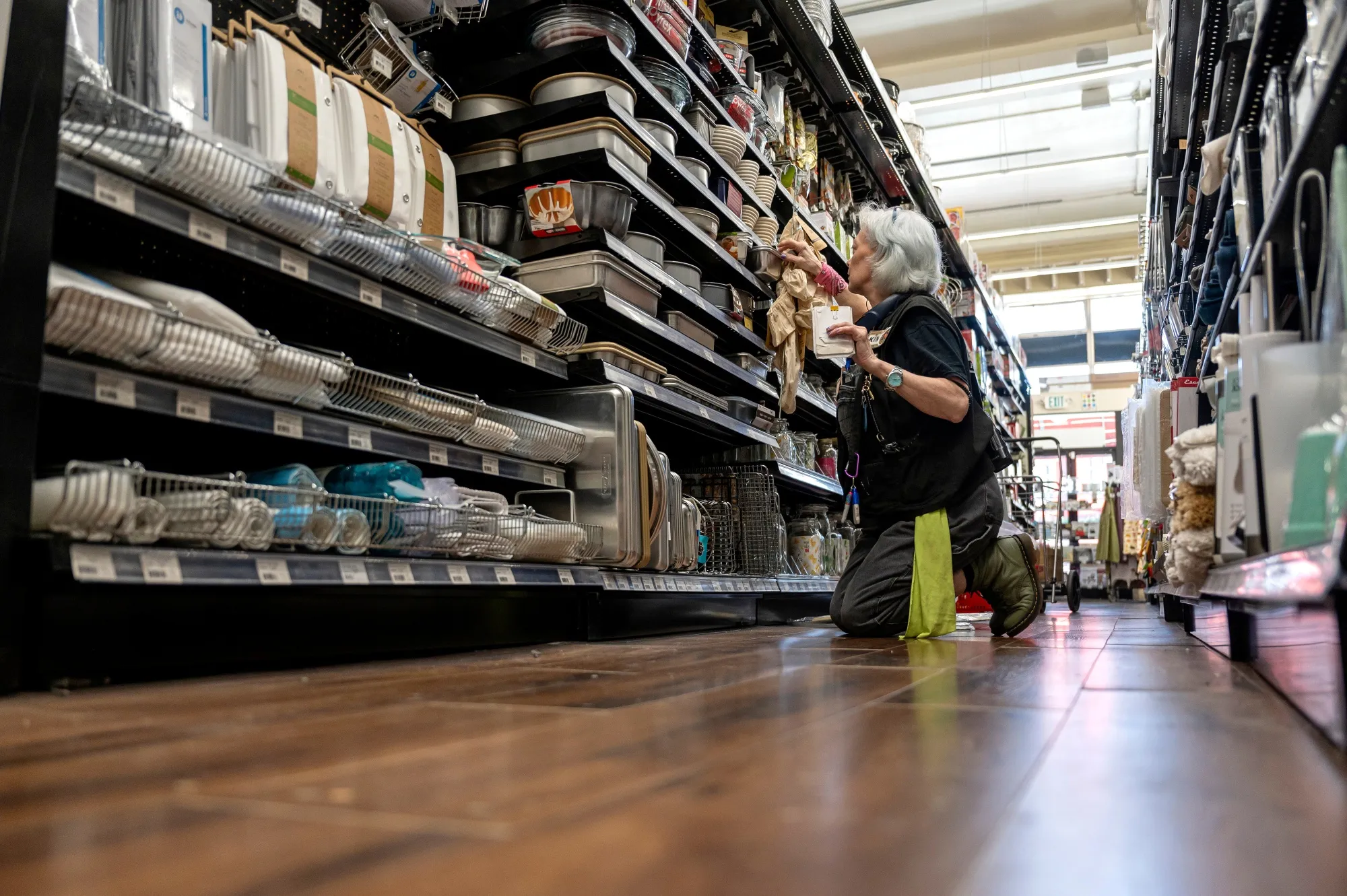 A worker stocks items at a hardware store in San Francisco.