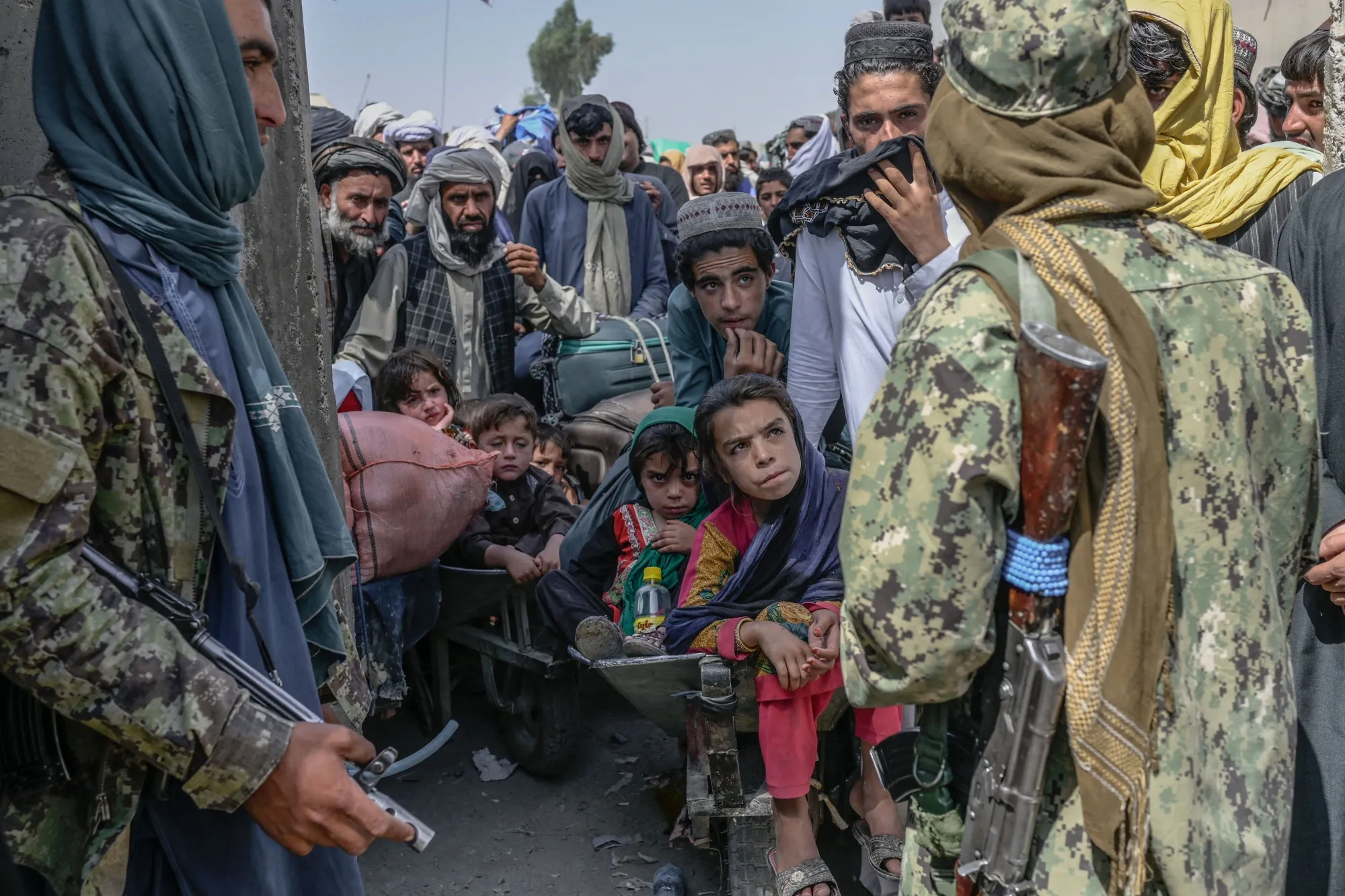 Taliban members stop people&nbsp;rushing to pass to Pakistan from the Afghanistan border on Sept. 25.