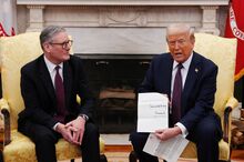 US President Donald Trump holds a letter from Britain's King Charles III during a meeting with British Prime Minister Keir Starmer in the Oval Office of the White House in Washington, DC, on February 27, 2025