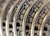 The embossed word Bitcoin sits on the edge of Bitcoins stacked in this arranged photograph in Danbury, U.K., on Thursday, Dec. 10, 2015. Bitcoin, the digital currency, climbed on Wednesday to hit its highest levels since early November, amid fresh speculation that the identity of Satoshi Nakamoto -- the virtual currency's creator -- may have finally been revealed.