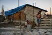 A mother holds her baby on Dec. 23, 2017, in San Isidro, Puerto Rico. Their home is under construction after being mostly destroyed by Hurricane Maria.